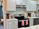 Well-equipped kitchen with modern stainless steel appliances, white cabinets, and sleek countertops at 21938 Catherine Ave, Port Charlotte, FL 33952