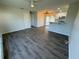 Spacious living room with hardwood floors, leading to a kitchen with a breakfast bar at 21938 Catherine Ave, Port Charlotte, FL 33952