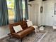 Inviting living room with a comfortable couch, large windows, and stylish decor at 21938 Catherine Ave, Port Charlotte, FL 33952