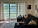 Cozy living room featuring a large picture window with natural light and stylish sectional seating at 21938 Catherine Ave, Port Charlotte, FL 33952