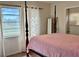 Comfortable bedroom with a four-poster bed and natural light streaming through the windows at 21938 Catherine Ave, Port Charlotte, FL 33952