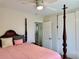 Main bedroom featuring a four-poster bed, closet, and view into the en-suite bathroom at 21938 Catherine Ave, Port Charlotte, FL 33952