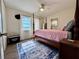 Cozy main bedroom featuring a four-poster bed, area rug, and ample natural light at 21938 Catherine Ave, Port Charlotte, FL 33952