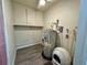 Utility room with a water heater, storage cabinets, and vinyl flooring at 21938 Catherine Ave, Port Charlotte, FL 33952