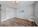 Cozy bedroom featuring wood-look flooring, neutral paint, and a table with two chairs at 23254 Stelling Ave, Port Charlotte, FL 33980