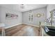 A comfortable bedroom features wood-look flooring, neutral paint, and natural light at 23254 Stelling Ave, Port Charlotte, FL 33980