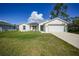 Charming single-story home with a well-manicured lawn and a two-car garage at 23254 Stelling Ave, Port Charlotte, FL 33980