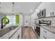 Modern kitchen featuring granite countertops, stainless steel appliances, and white cabinetry at 23254 Stelling Ave, Port Charlotte, FL 33980