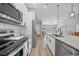 Well-appointed kitchen with granite counters, stainless steel appliances and light wood flooring at 23254 Stelling Ave, Port Charlotte, FL 33980