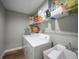 Laundry room includes washer, dryer, storage shelves, and a utility sink at 23254 Stelling Ave, Port Charlotte, FL 33980