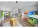 Open-concept living space featuring modern decor, wood floors, and bright, airy ambiance at 23254 Stelling Ave, Port Charlotte, FL 33980