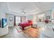 A well lit main bedroom features a ceiling fan, tray ceiling and an ensuite bathroom at 23254 Stelling Ave, Port Charlotte, FL 33980