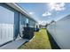 Exterior showcasing backyard with green grass and a white vinyl fence at 2405 Vancouver Ln, North Port, FL 34286