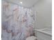 Cozy bathroom with a marble-patterned shower curtain and white fixtures at 2405 Vancouver Ln, North Port, FL 34286