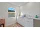 Bathroom with a white vanity, granite countertop, and window for natural lighting at 2405 Vancouver Ln, North Port, FL 34286