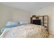 Comfortable bedroom with a floral-patterned bedspread and built-in shelving unit at 2405 Vancouver Ln, North Port, FL 34286