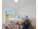 Well-lit bedroom with a large window and a bed with blue bedding at 2405 Vancouver Ln, North Port, FL 34286
