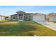 Charming single-story home featuring a manicured front yard and two-car garage at 2405 Vancouver Ln, North Port, FL 34286