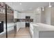 Well-lit kitchen with stainless steel appliances, custom cabinets, and stone countertops at 2405 Vancouver Ln, North Port, FL 34286