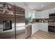 A detailed view of the kitchen featuring stainless steel appliances and white cabinetry at 2405 Vancouver Ln, North Port, FL 34286