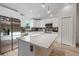 Bright kitchen with stainless steel appliances, an island and a mosaic tile backsplash at 2405 Vancouver Ln, North Port, FL 34286