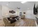 Bright living room featuring wood flooring and a modern ceiling fan at 2405 Vancouver Ln, North Port, FL 34286