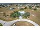 Expansive aerial view of a home surrounded by mature trees, and a long private driveway at 24344 Penhollow Ct, Punta Gorda, FL 33955