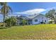 Lush backyard featuring a screened lanai, well maintained lawn, and mature landscaping at 24344 Penhollow Ct, Punta Gorda, FL 33955