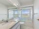 Bright bathroom showcasing a tub with glass doors, white cabinets, and marble countertops at 24344 Penhollow Ct, Punta Gorda, FL 33955