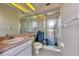 Bright bathroom featuring a glass-enclosed shower, white tiling, and a pink vanity at 24344 Penhollow Ct, Punta Gorda, FL 33955