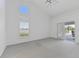 Spacious bedroom boasts carpeted floors, lots of light, and glass doors to the lanai at 24344 Penhollow Ct, Punta Gorda, FL 33955