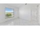 This bedroom features marble tile flooring, white walls and a window at 24344 Penhollow Ct, Punta Gorda, FL 33955