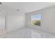This bedroom features a window, marble tile flooring, and white walls at 24344 Penhollow Ct, Punta Gorda, FL 33955