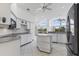 Bright kitchen with white cabinets, granite countertops, stainless steel appliances, and tile floors at 24344 Penhollow Ct, Punta Gorda, FL 33955