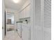 Bright laundry room featuring white cabinets, marble tile flooring, and standard laundry units at 24344 Penhollow Ct, Punta Gorda, FL 33955