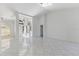 Large, bright living area featuring modern tile floors and elegant architectural details at 24344 Penhollow Ct, Punta Gorda, FL 33955