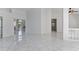 Open-concept living room with tile floors and serene views through glass doors at 24344 Penhollow Ct, Punta Gorda, FL 33955