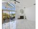Living room with tile flooring, a fireplace and sliding glass doors leading to a patio at 24344 Penhollow Ct, Punta Gorda, FL 33955