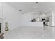 Spacious living room with tile flooring, a fireplace, and a view into the kitchen at 24344 Penhollow Ct, Punta Gorda, FL 33955