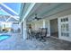 Covered outdoor patio with dining set, overlooking the pool and lush backyard at 24344 Penhollow Ct, Punta Gorda, FL 33955