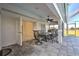Covered patio with dining table and chairs, perfect for outdoor entertaining at 24344 Penhollow Ct, Punta Gorda, FL 33955