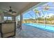 Screened-in pool area with seating and views of the lush landscaping at 24344 Penhollow Ct, Punta Gorda, FL 33955