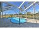 Beautiful pool in a screened-in lanai with tropical landscaping and sunny skies at 24344 Penhollow Ct, Punta Gorda, FL 33955