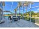 Poolside view of the lanai with outdoor seating and tropical landscaping at 24344 Penhollow Ct, Punta Gorda, FL 33955