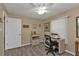 A well-lit bedroom featuring neutral walls, laminate flooring, and a cozy office area with a sewing machine at 25202 Chiclayo Ave, Punta Gorda, FL 33983