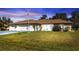 Charming single-story home with a well-manicured front lawn and a three-car garage at 25202 Chiclayo Ave, Punta Gorda, FL 33983