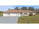 Charming single-story home with a well-manicured lawn and a three-car garage at 25202 Chiclayo Ave, Punta Gorda, FL 33983