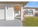 Inviting front entrance with decorative details, an ADT sign, and lush greenery at 25202 Chiclayo Ave, Punta Gorda, FL 33983