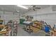 Garage with a ceiling fan, with tools, golf bags, and workbenches at 25202 Chiclayo Ave, Punta Gorda, FL 33983