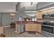 Open kitchen with wood cabinets and stainless steel appliances at 25202 Chiclayo Ave, Punta Gorda, FL 33983